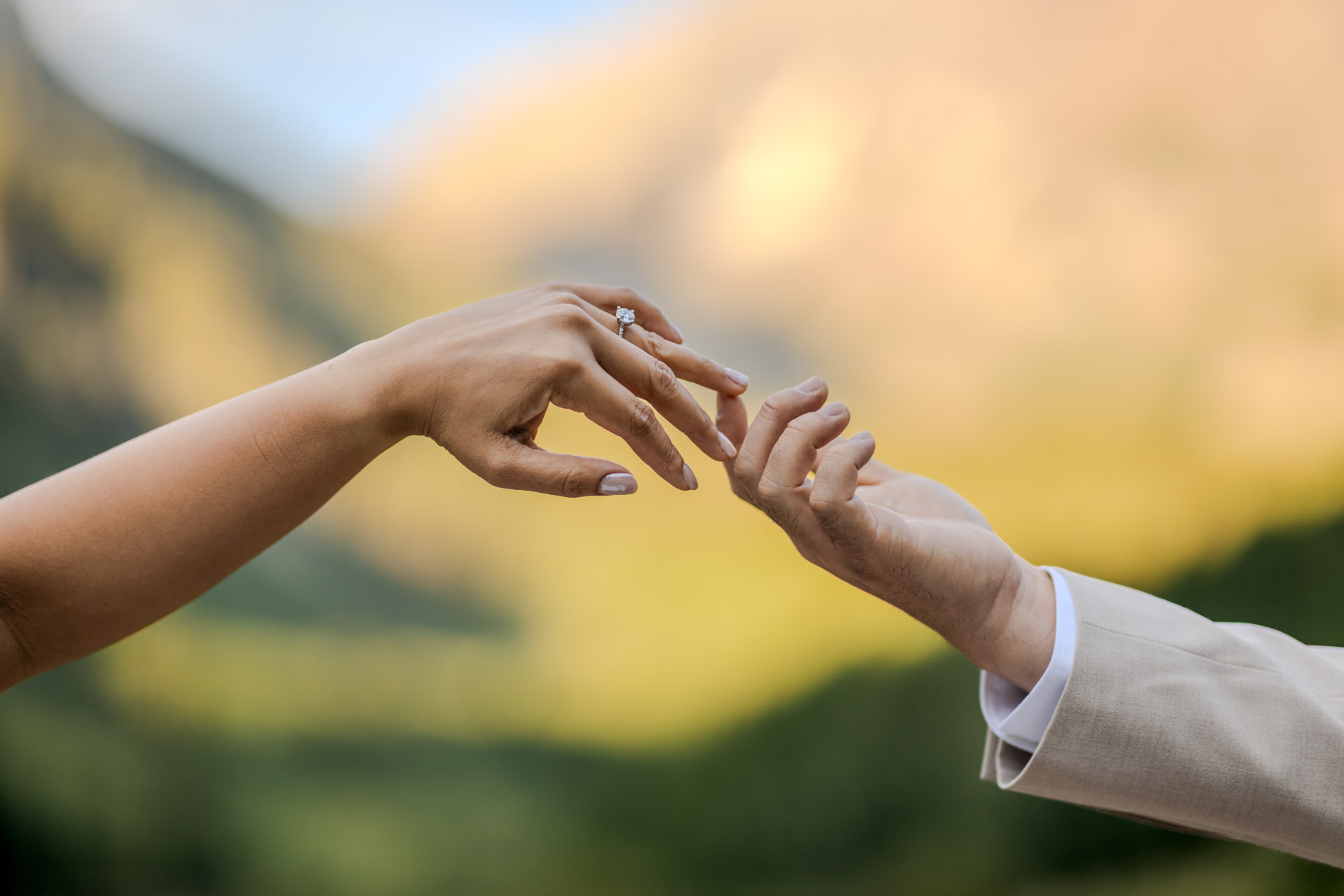 Couple's hands meeting during their Maroon Bells elopement near Aspen, Colorado